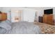 Comfortable main bedroom showcasing access to the ensuite bathroom and walk in closet at 7641 Armonk Ln, Wesley Chapel, FL 33545