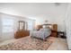 Bright main bedroom with natural light, a large decorative rug, and wooden furniture set at 7641 Armonk Ln, Wesley Chapel, FL 33545