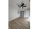 This bedroom features wood-look floors, a ceiling fan, and a closet with sliding doors at 7703 Glenview Ln, Tampa, FL 33615