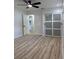 This bedroom features wood-look floors, a ceiling fan, and a closet with sliding doors at 7703 Glenview Ln, Tampa, FL 33615