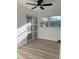 This bedroom features wood-look floors, a ceiling fan, and a closet with sliding doors at 7703 Glenview Ln, Tampa, FL 33615