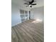 This bedroom features wood-look floors, a ceiling fan, and a closet with sliding doors at 7703 Glenview Ln, Tampa, FL 33615