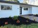 Inviting single-story home showcases fresh landscaping with black mulch and vibrant plants enhancing its curb appeal at 7703 Glenview Ln, Tampa, FL 33615