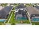Aerial view of the home featuring a large screened in pool, lush lawn, and fenced yard at 8019 Marbella Creek Ave, Tampa, FL 33625
