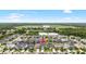 Aerial view of a residential area with a pond and school, marked with an arrow pointing to the home at 8019 Marbella Creek Ave, Tampa, FL 33625