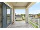Relaxing balcony area with wood-look tile, white railings and beautiful neighborhood view at 8019 Marbella Creek Ave, Tampa, FL 33625