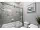 Cozy bathroom with a shower over tub, sliding glass doors and attractive décor at 8019 Marbella Creek Ave, Tampa, FL 33625