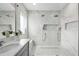 Elegant bathroom featuring double shower heads, marble-look tile, and decorative inset shelves at 8019 Marbella Creek Ave, Tampa, FL 33625