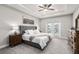 Main bedroom with tray ceiling, ceiling fan, ensuite bath, and large windows at 8019 Marbella Creek Ave, Tampa, FL 33625
