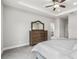 Main bedroom with tray ceiling, ceiling fan, carpet floor, and a dresser at 8019 Marbella Creek Ave, Tampa, FL 33625