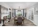 Elegant dining room featuring a long table, modern chandelier, and stylish decor at 8019 Marbella Creek Ave, Tampa, FL 33625