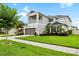 Attractive two-story home with balcony, two-car garage, and lush landscaping at 8019 Marbella Creek Ave, Tampa, FL 33625