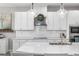 Beautiful kitchen with stainless steel appliances, white cabinets, and quartz countertops at 8019 Marbella Creek Ave, Tampa, FL 33625