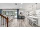 Spacious living room with open floor plan, wood floors, and sliding glass doors to patio at 8019 Marbella Creek Ave, Tampa, FL 33625