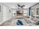 Cozy living room with plush sofa, TV, ceiling fan, and sliding glass doors at 8019 Marbella Creek Ave, Tampa, FL 33625