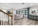 Open living space with wood floors, comfortable seating, and sliding doors to outdoor area at 8019 Marbella Creek Ave, Tampa, FL 33625