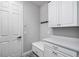 Mudroom featuring a bench, storage cabinets and drawers, coat hooks and access to the garage at 8019 Marbella Creek Ave, Tampa, FL 33625