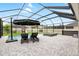 Covered swimming pool area with an umbrella table, sunbeds and an integrated hot tub at 8019 Marbella Creek Ave, Tampa, FL 33625