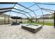Screened-in swimming pool and integrated hot tub with a paved patio and backyard playground at 8019 Marbella Creek Ave, Tampa, FL 33625