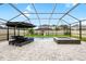 Screened-in pool featuring a hot tub, sun loungers, and splash fountains on a paved patio at 8019 Marbella Creek Ave, Tampa, FL 33625