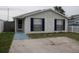Charming single-story home featuring a stone facade, blue shutters, and a well-maintained front yard at 8234 Ravencroft Dr, Tampa, FL 33615