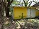 Back side of a cottage surrounded by foliage at 8617 Broad St, New Port Richey, FL 34654