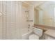 Bathroom with tub, shower, toilet, vanity and a large mirror with decorative wallpaper at 921 Linn Harbor Ct, Tarpon Springs, FL 34689