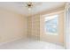 Bedroom featuring built in shelves, tile floors, cream walls, a window and bi-fold door closet at 921 Linn Harbor Ct, Tarpon Springs, FL 34689