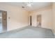 Spacious bedroom features neutral carpeting, ensuite bathroom, walk-in closet, and ceiling fan at 921 Linn Harbor Ct, Tarpon Springs, FL 34689