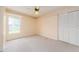 Bedroom with carpet, cream walls, a ceiling fan, closet with bi-fold doors, and window at 921 Linn Harbor Ct, Tarpon Springs, FL 34689