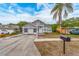 Charming single-Gathering home featuring a well-maintained front yard with a palm tree at 921 Linn Harbor Ct, Tarpon Springs, FL 34689