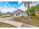 Charming single-Gathering home featuring a well-maintained front yard with a palm tree at 921 Linn Harbor Ct, Tarpon Springs, FL 34689