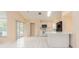 Functional kitchen with white cabinets and bar perfect for meal prep and casual dining at 921 Linn Harbor Ct, Tarpon Springs, FL 34689