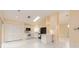 Open-concept kitchen featuring white cabinets and tiled floors at 921 Linn Harbor Ct, Tarpon Springs, FL 34689