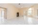 Comfortable living area with tile floors, ceiling fan, and multiple entryways for seamless flow at 921 Linn Harbor Ct, Tarpon Springs, FL 34689