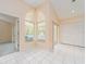Bright sunroom with tile flooring and arched windows at 921 Linn Harbor Ct, Tarpon Springs, FL 34689