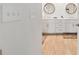 Bright bathroom featuring double sinks, white cabinets and wood-look flooring at 960 Starkey Rd # 7503, Largo, FL 33771