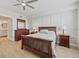 Comfortable bedroom featuring a wooden bed, dresser, and views into the ensuite bath at 960 Starkey Rd # 7503, Largo, FL 33771
