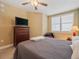 Well-lit bedroom featuring a bed, ceiling fan, window with blinds, dresser, and comfy chair at 960 Starkey Rd # 7503, Largo, FL 33771