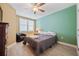 Cozy bedroom featuring a bed, ceiling fan, window with blinds, and comfortable chair, perfect for relaxation at 960 Starkey Rd # 7503, Largo, FL 33771