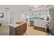 Open kitchen featuring an island, stainless steel appliances, and views of the spacious living area at 960 Starkey Rd # 7503, Largo, FL 33771