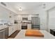 Modern kitchen with stainless steel appliances and large island with counter seating at 960 Starkey Rd # 7503, Largo, FL 33771
