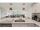 Kitchen and living area with stylish pendant lights and stainless appliances overlooking a beautiful vista at 960 Starkey Rd # 7503, Largo, FL 33771