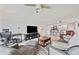 Spacious living room featuring stylish furnishings, entertainment center, and seamless flow into the dining area at 960 Starkey Rd # 7503, Largo, FL 33771