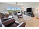 Well-lit living room with comfortable seating, a ceiling fan, and views of the outdoors through large windows at 960 Starkey Rd # 7503, Largo, FL 33771