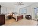 Bright main bedroom with a ceiling fan, board and batten accent wall, and an ensuite bathroom at 960 Starkey Rd # 7503, Largo, FL 33771