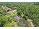 An aerial shot showcases a home with a private pool, a pond, and lush greenery, offering a serene and secluded living experience at 10113 Bell Creek Dr, Riverview, FL 33569