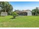 Expansive backyard with green grass, shed, mature trees and screened in pool at 10113 Bell Creek Dr, Riverview, FL 33569