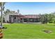 Backyard view featuring pool with screened in patio and mature trees at 10113 Bell Creek Dr, Riverview, FL 33569
