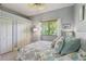 Comfortable bedroom with ceiling fan, large window, and closets offering ample storage space and soft natural light at 10113 Bell Creek Dr, Riverview, FL 33569